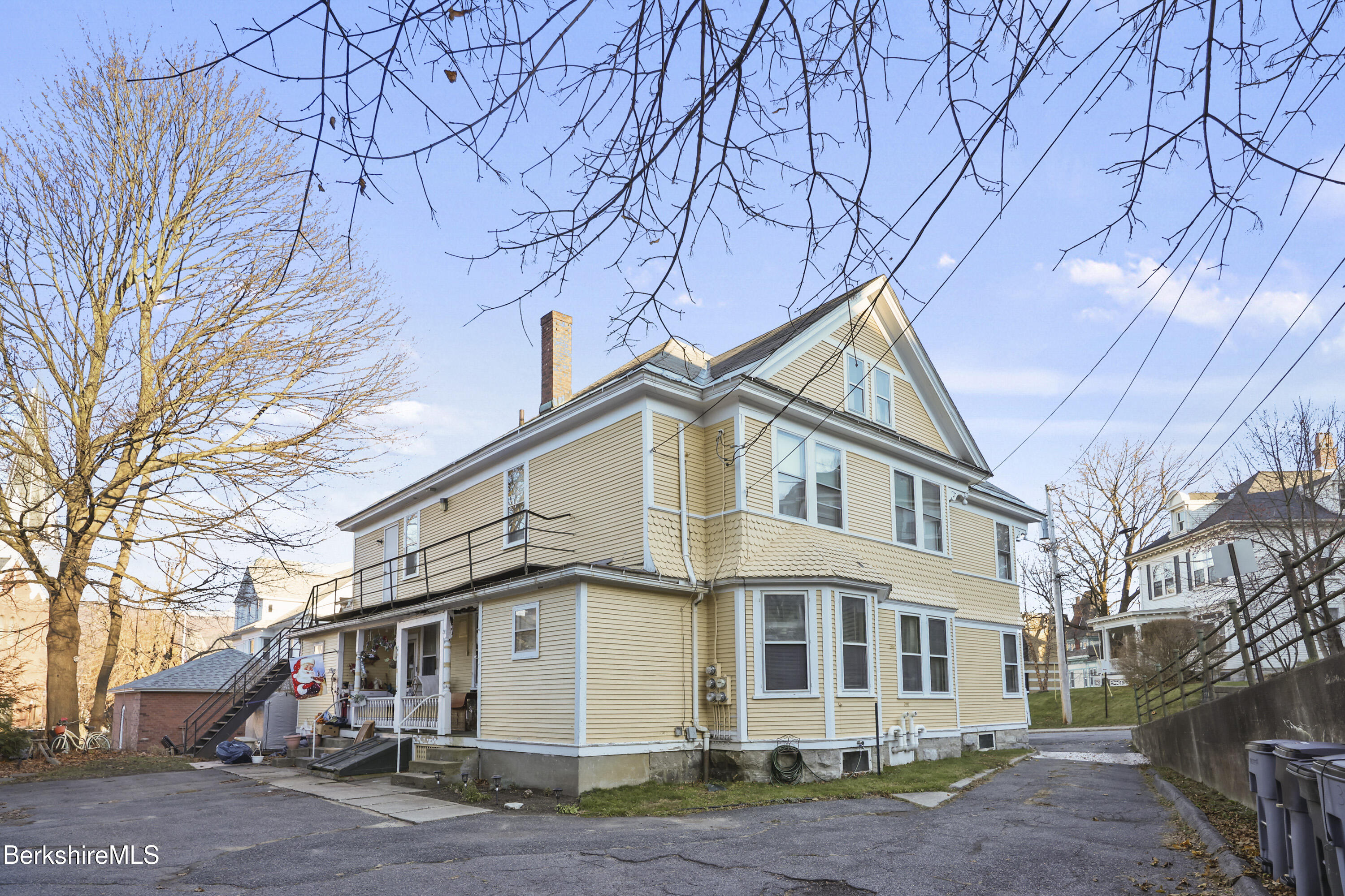 3-5 Melrose Street Adams, MA 01220 - Photo 6 of 37 a view of a white house with a large tree
