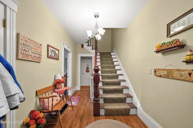a living room with furniture and stairs