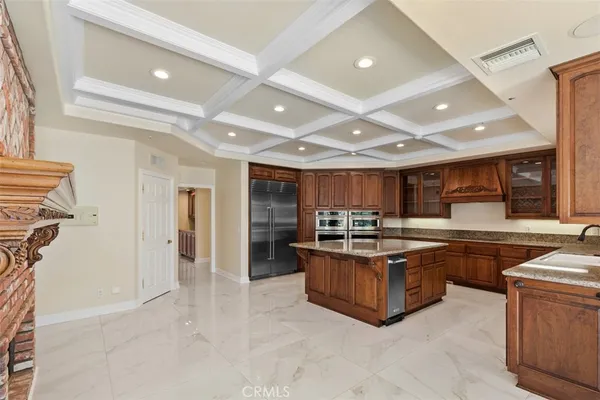 a kitchen with stainless steel appliances granite countertop a sink and a refrigerator