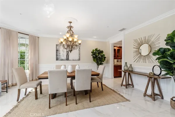 a view of a dining room with furniture and a chandelier
