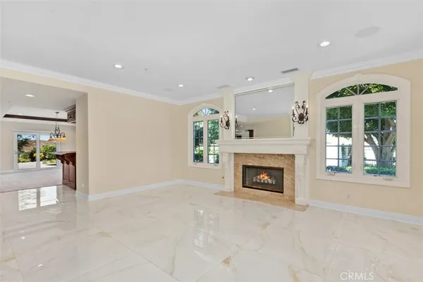 a view of a livingroom with a fireplace window and a fireplace