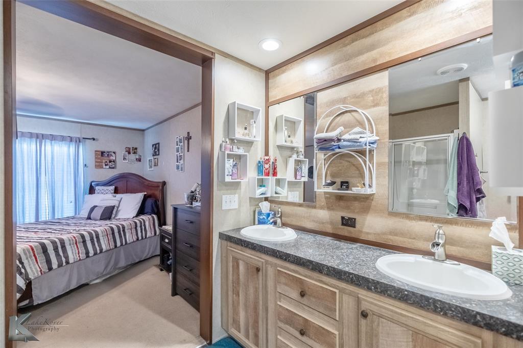 1301 Roma Lane Abilene, TX 79603 - Photo 18 of 20 Ensuite bathroom featuring double vanity and a stall shower