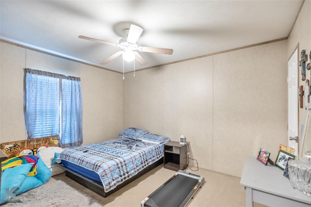 1301 Roma Lane Abilene, TX 79603 - Photo 20 of 20 Carpeted bedroom featuring ceiling fan and ornamental molding
