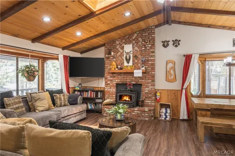 a living room with fireplace furniture and a flat screen tv