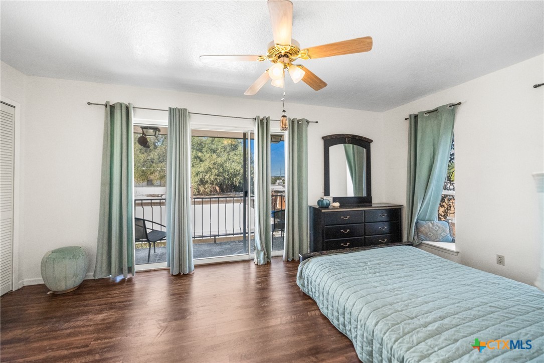 619 Strings Drive, Unit 619 San Antonio, TX 78216 - Photo 29 of 48 a bedroom with a bed and a chandelier