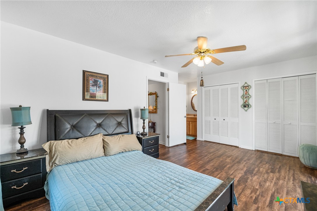 619 Strings Drive, Unit 619 San Antonio, TX 78216 - Photo 32 of 48 a bedroom with a bed and a chandelier