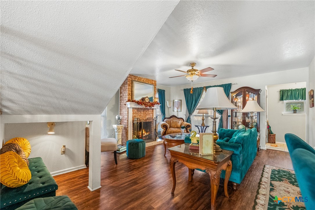619 Strings Drive, Unit 619 San Antonio, TX 78216 - Photo 6 of 48 a living room with furniture a chandelier and a wooden floor