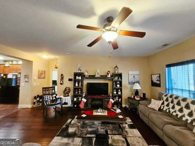 a living room with lots of furniture and a flat screen tv