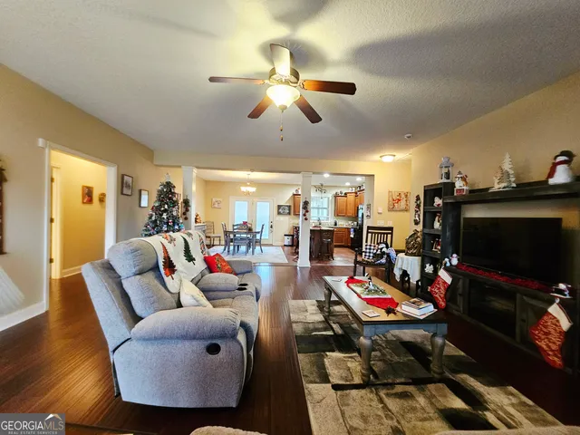 a living room with furniture and wooden floor