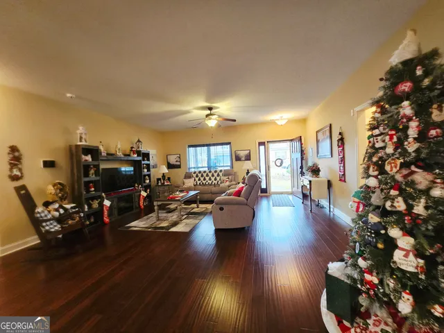 a living room with furniture stairs and a flat screen tv