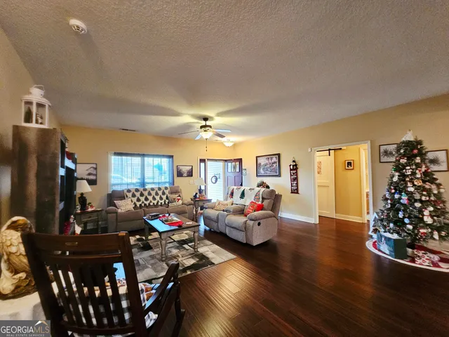 a view of a dining room with furniture and wooden floor