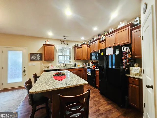 a kitchen that has a table and chairs in it