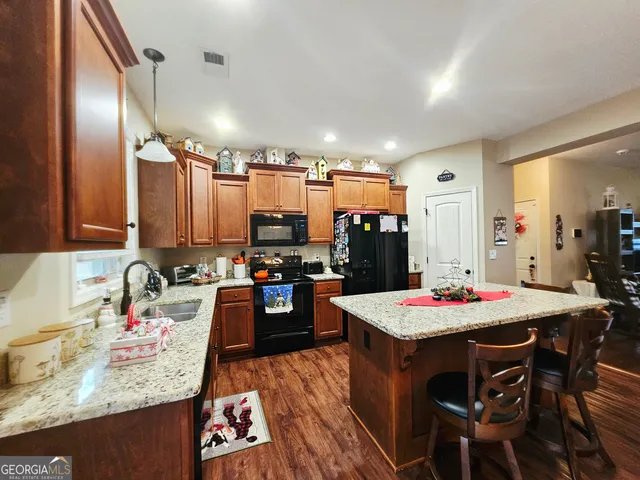a dining room with furniture and wooden floor