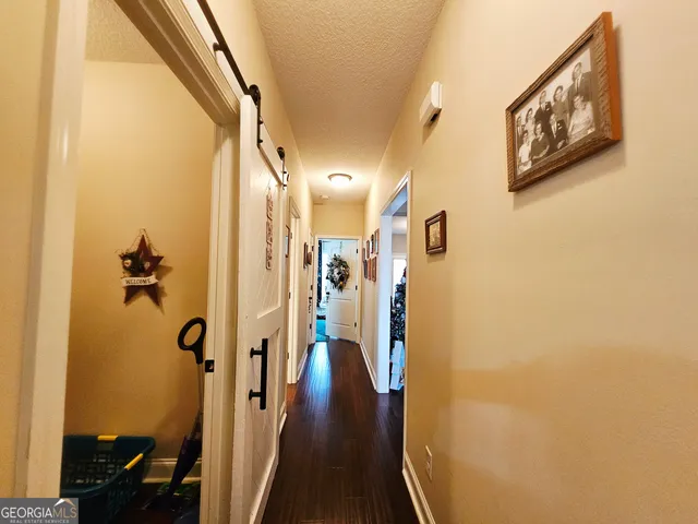 a bathroom with a granite countertop toilet a sink and a mirror