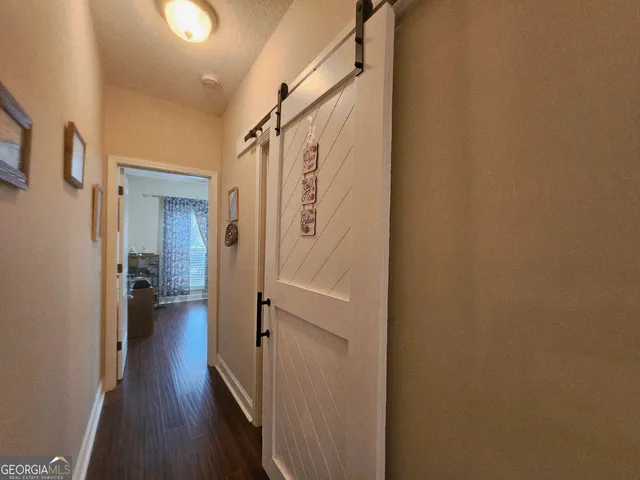 a bedroom with furniture and a flat screen tv