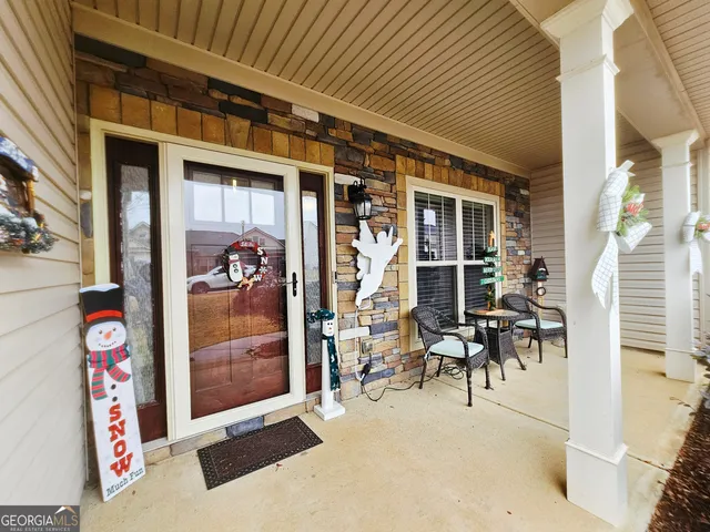 a view of a patio with table and chairs