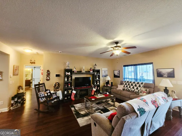 a living room with furniture and wooden floor