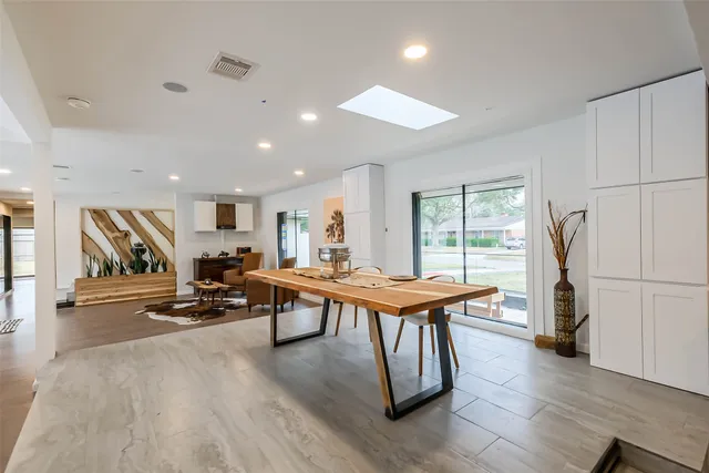 a living room with furniture a wooden floor and a window