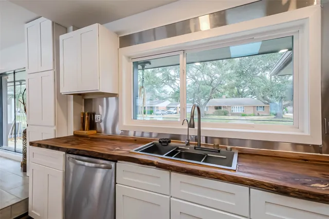 a kitchen with granite countertop a sink and a window