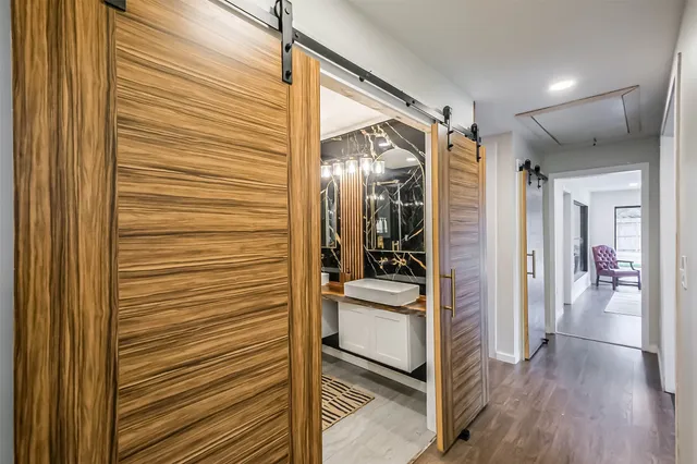 a view of a hallway and a livingroom with furniture
