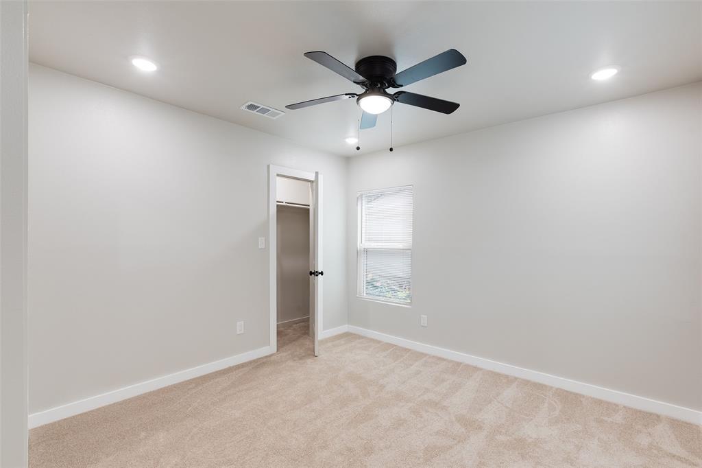 3110 Utah Avenue Dallas, TX 75216 - Photo 12 of 26 an empty room with closet and a chandelier fan
