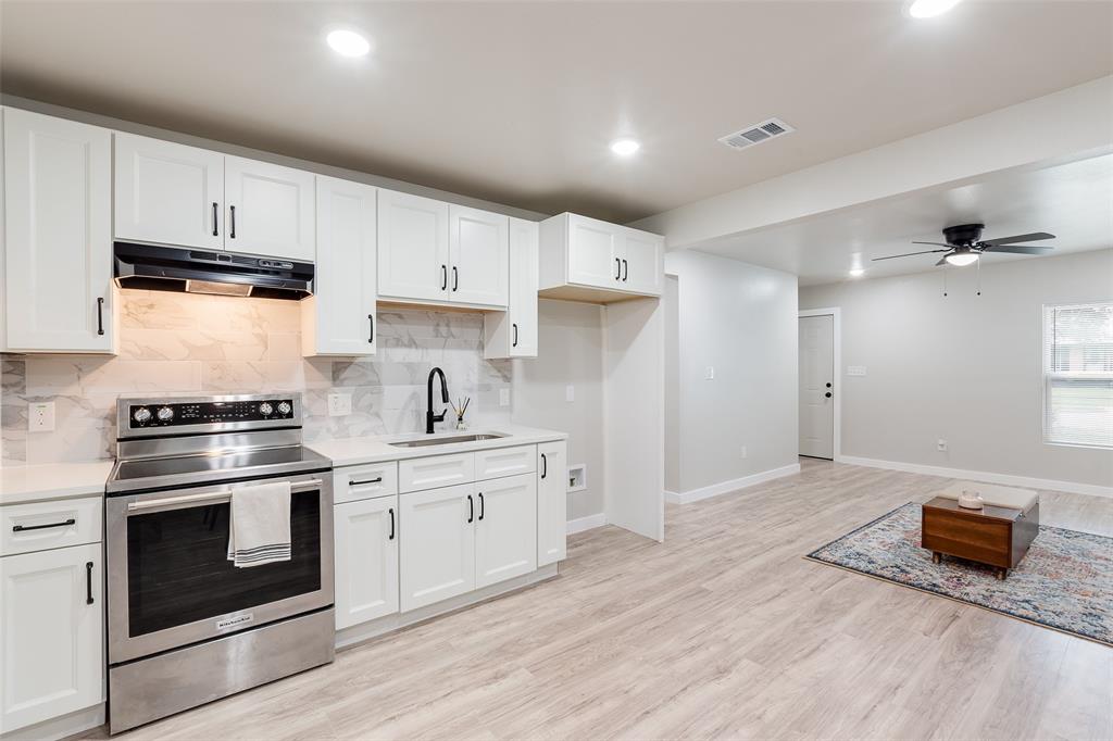 3110 Utah Avenue Dallas, TX 75216 - Photo 4 of 26 a kitchen with stainless steel appliances granite countertop a stove a sink and a refrigerator
