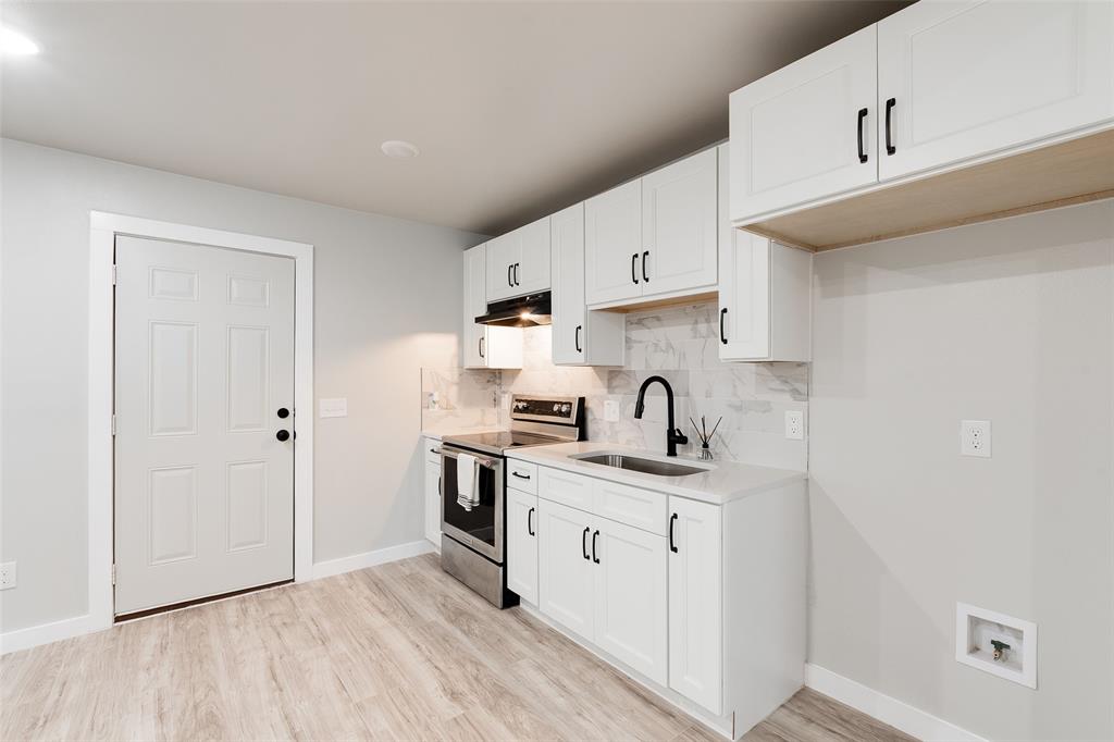 3110 Utah Avenue Dallas, TX 75216 - Photo 5 of 26 a kitchen with stainless steel appliances a sink a stove a refrigerator and cabinets