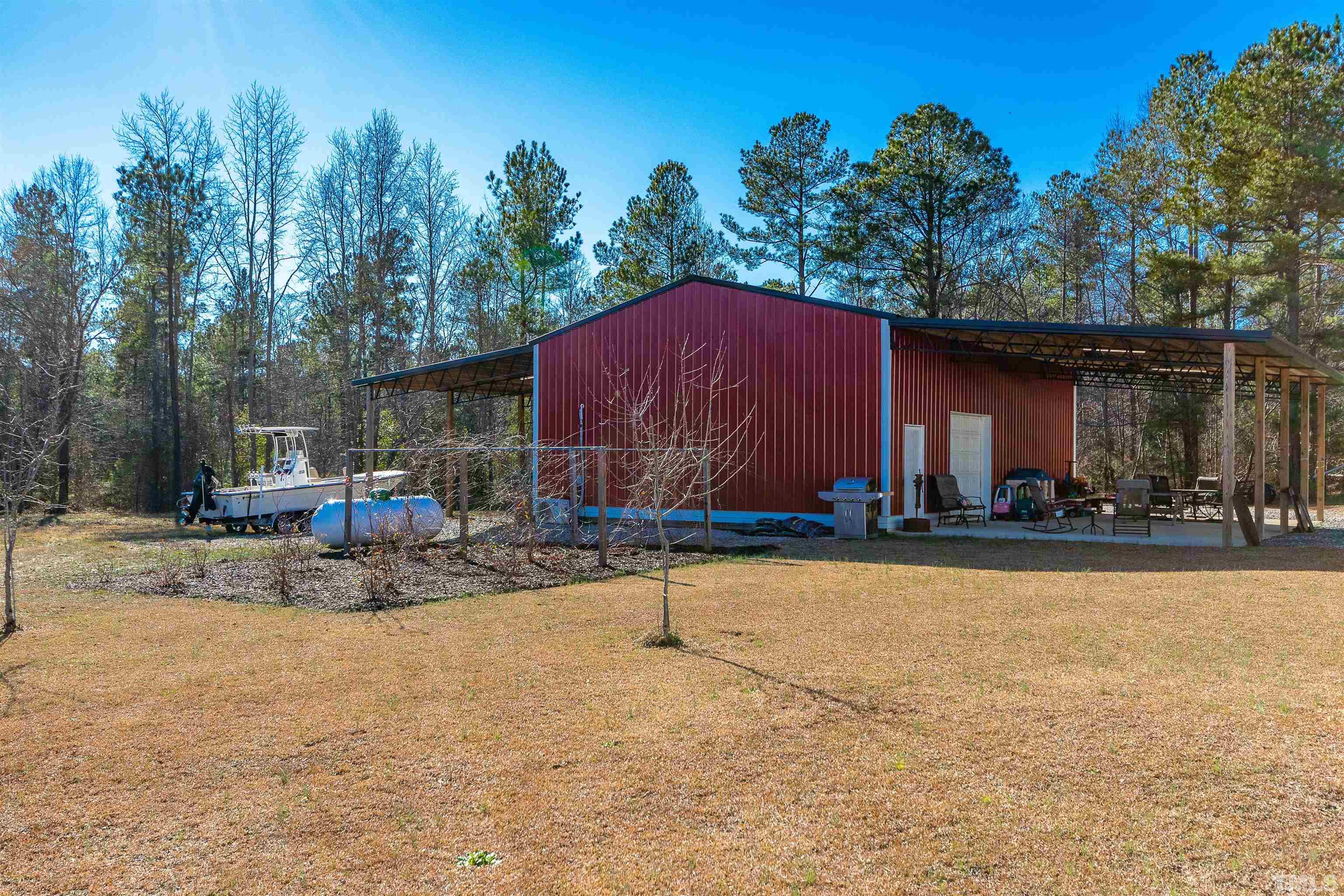 4300 Debnam Road Zebulon, NC 27597 - Photo 17 of 54 a view of a house with backyard and sitting area