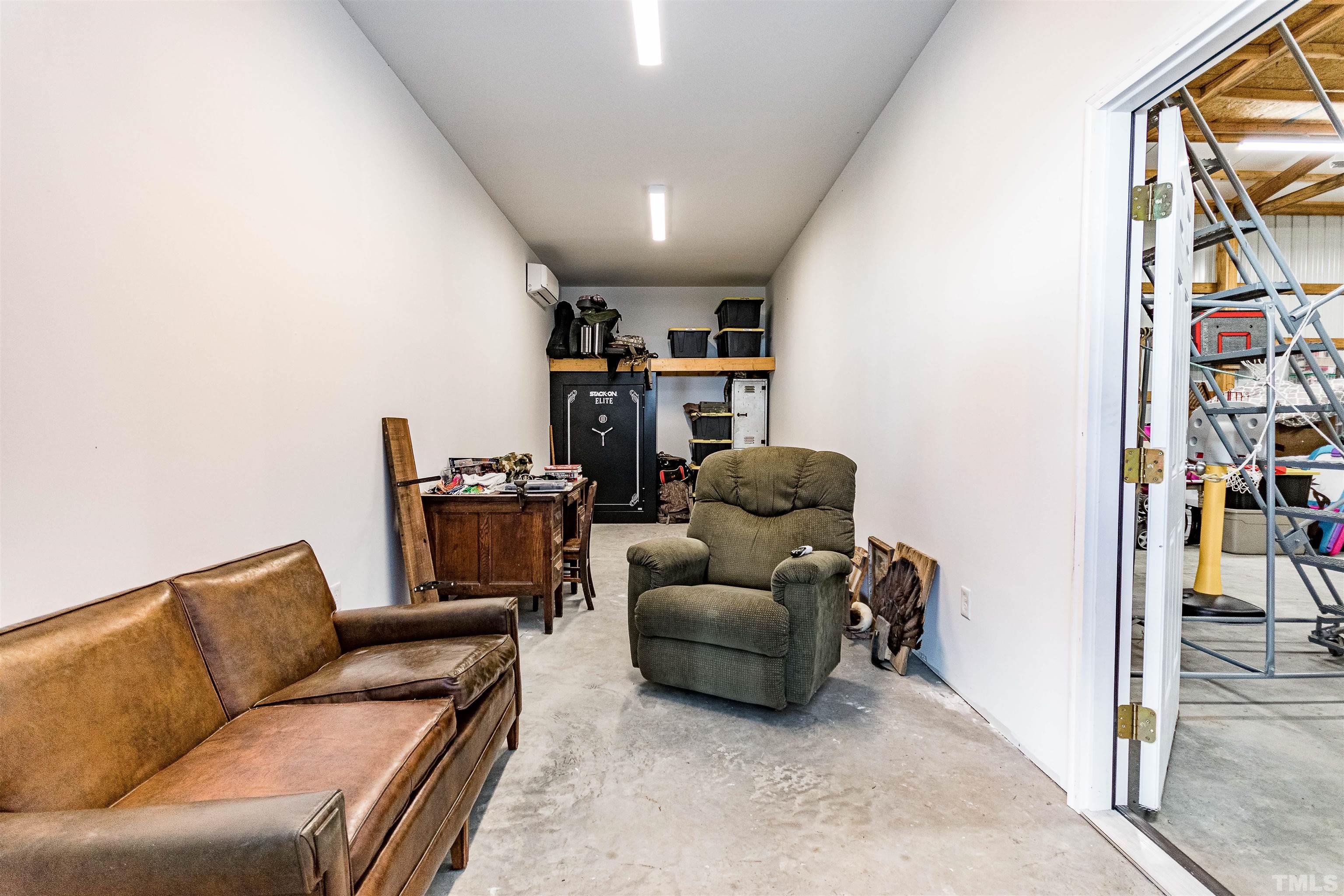 4300 Debnam Road Zebulon, NC 27597 - Photo 18 of 54 a living room with furniture and a book shelf