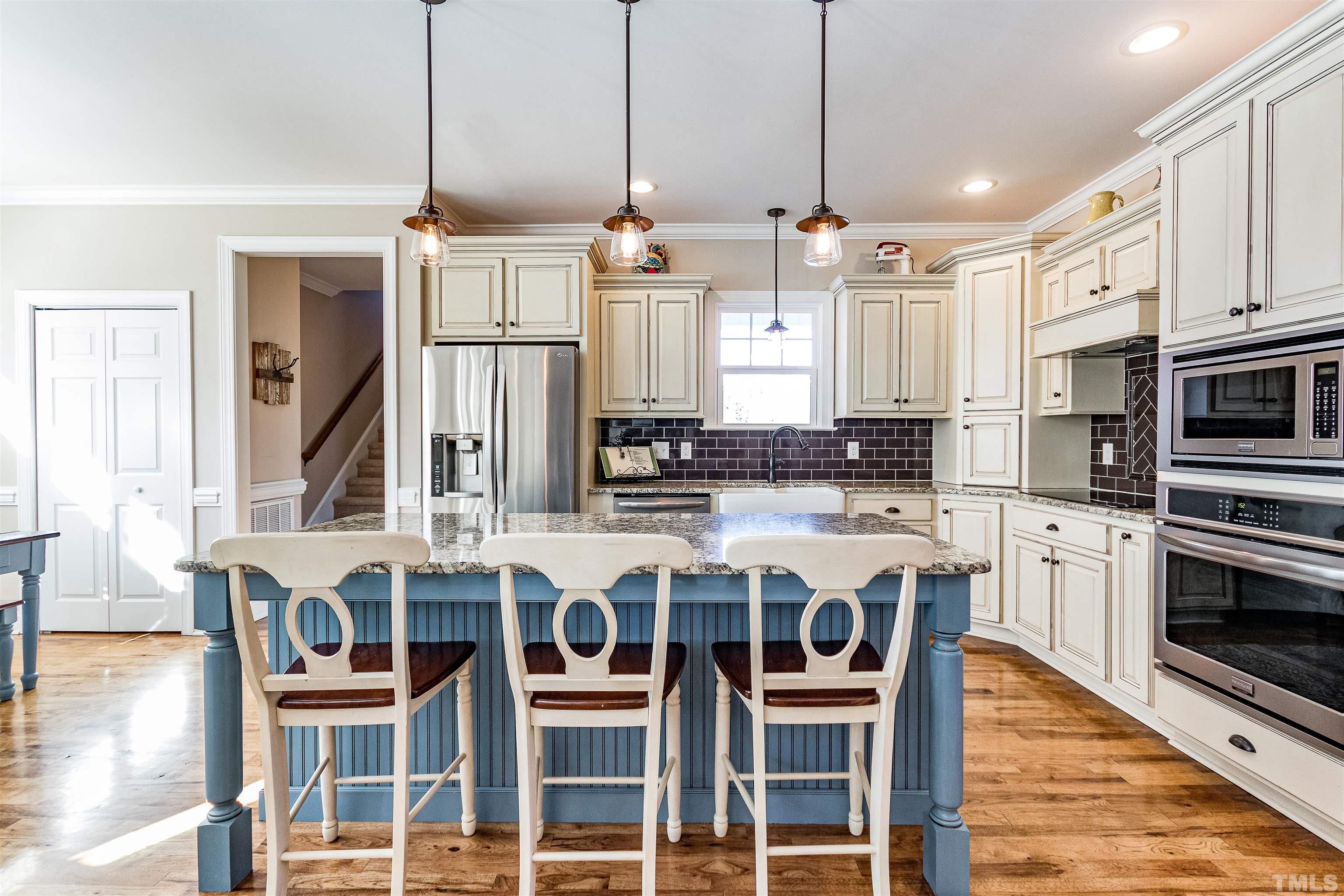 4300 Debnam Road Zebulon, NC 27597 - Photo 28 of 54 a kitchen with stainless steel appliances granite countertop a stove and cabinets