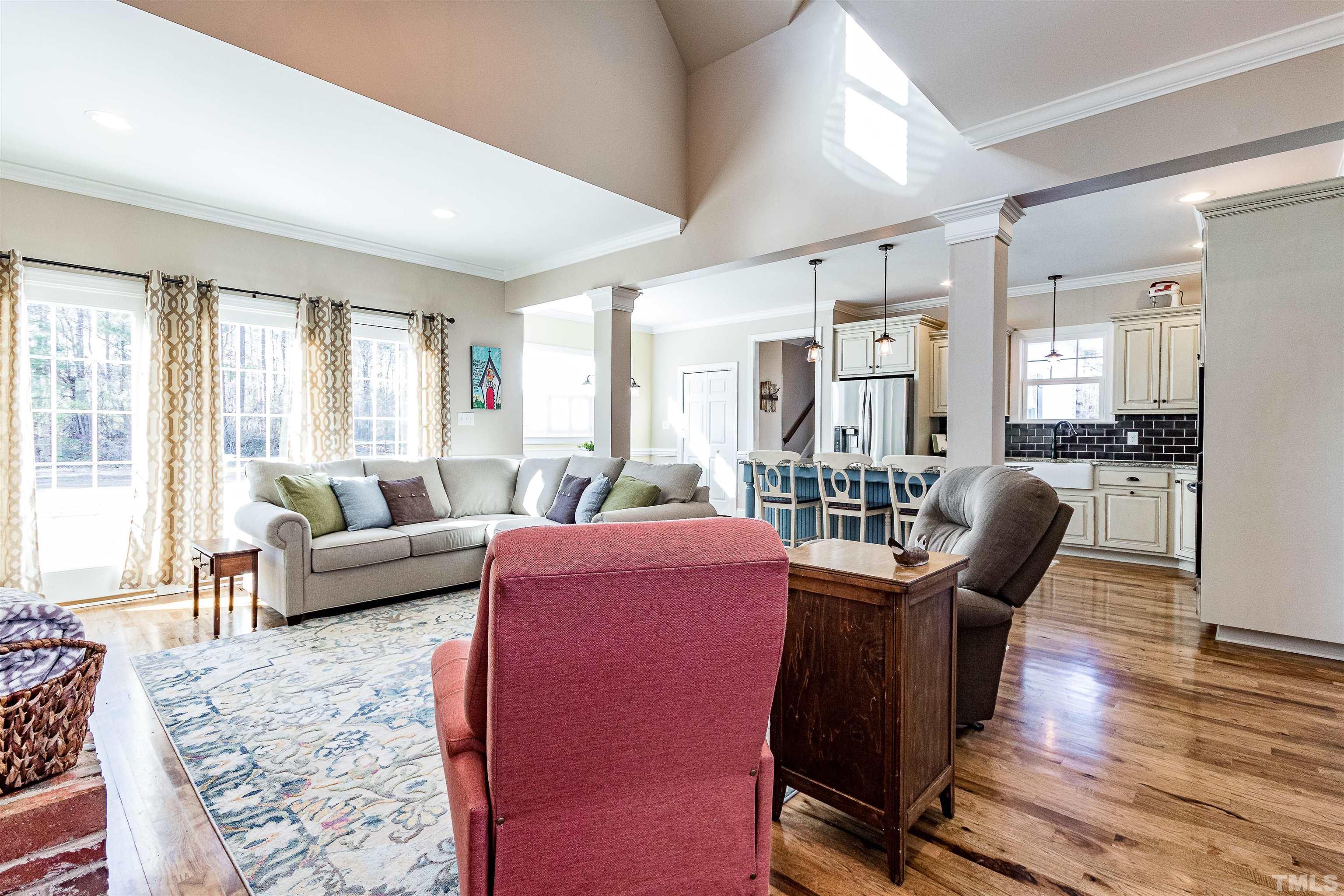 4300 Debnam Road Zebulon, NC 27597 - Photo 32 of 54 a living room with furniture wooden floor and a large window
