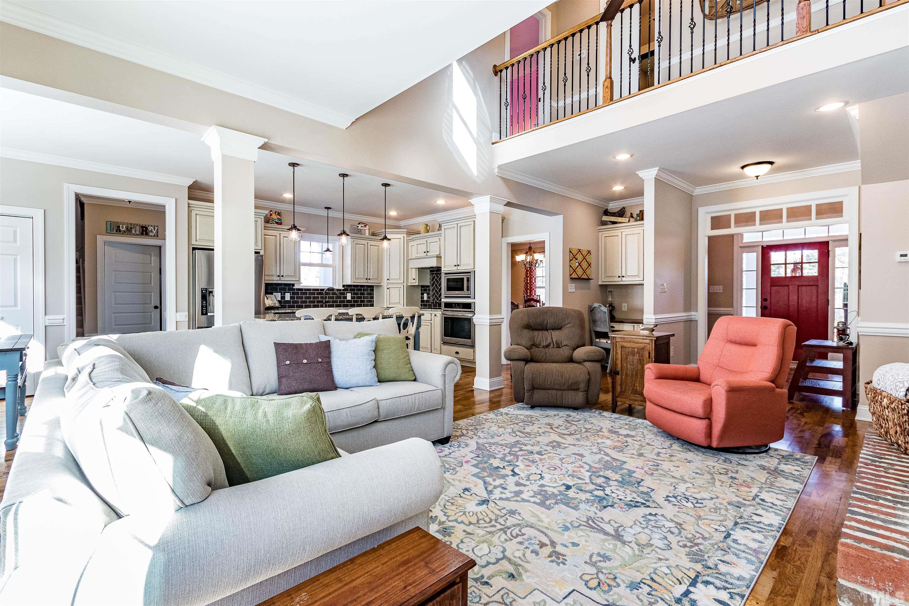 4300 Debnam Road Zebulon, NC 27597 - Photo 34 of 54 a living room with furniture kitchen view and a chandelier