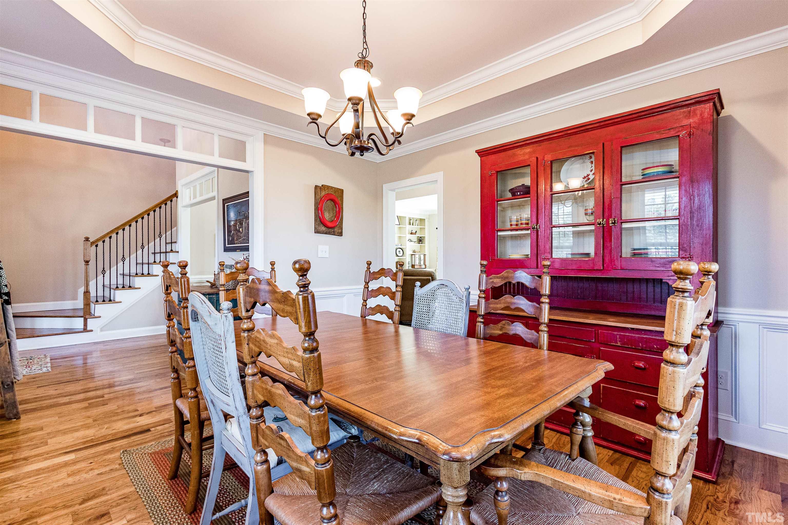 4300 Debnam Road Zebulon, NC 27597 - Photo 35 of 54 a dining room with furniture a chandelier and wooden floor