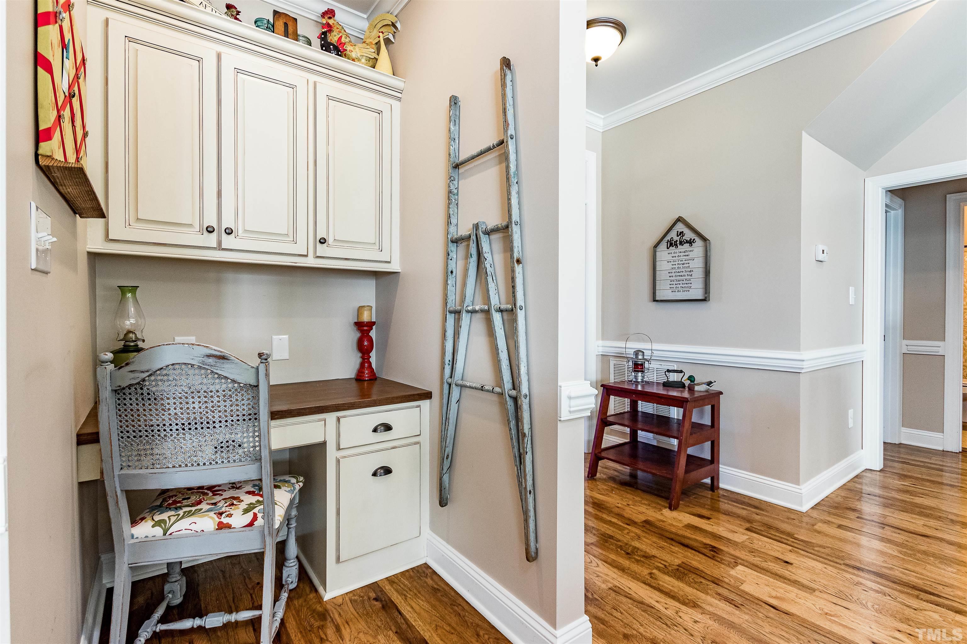 4300 Debnam Road Zebulon, NC 27597 - Photo 37 of 54 a kitchen with stainless steel appliances cabinets and a wooden floor