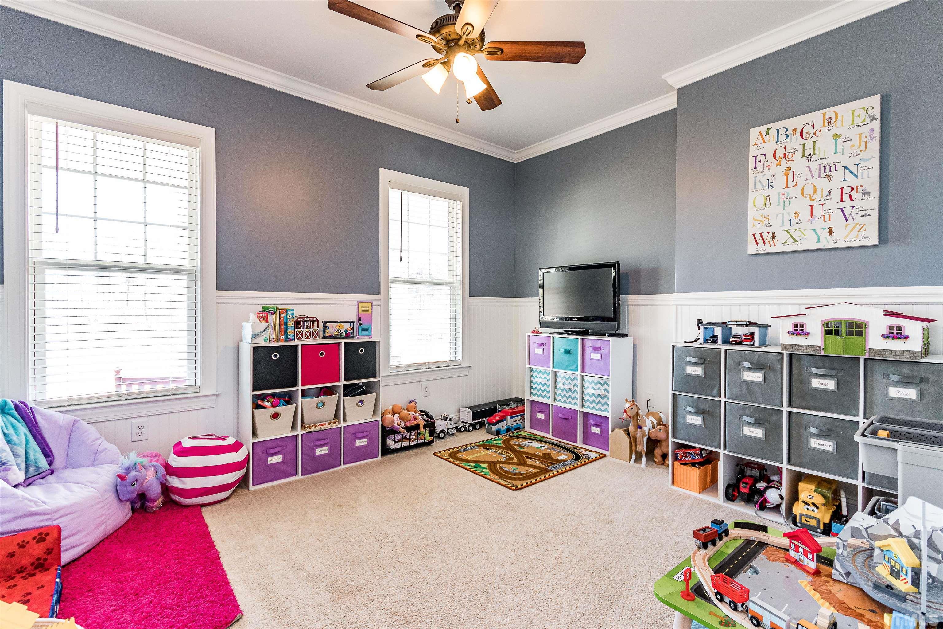 4300 Debnam Road Zebulon, NC 27597 - Photo 38 of 54 a bedroom with furniture a flat screen tv and a window