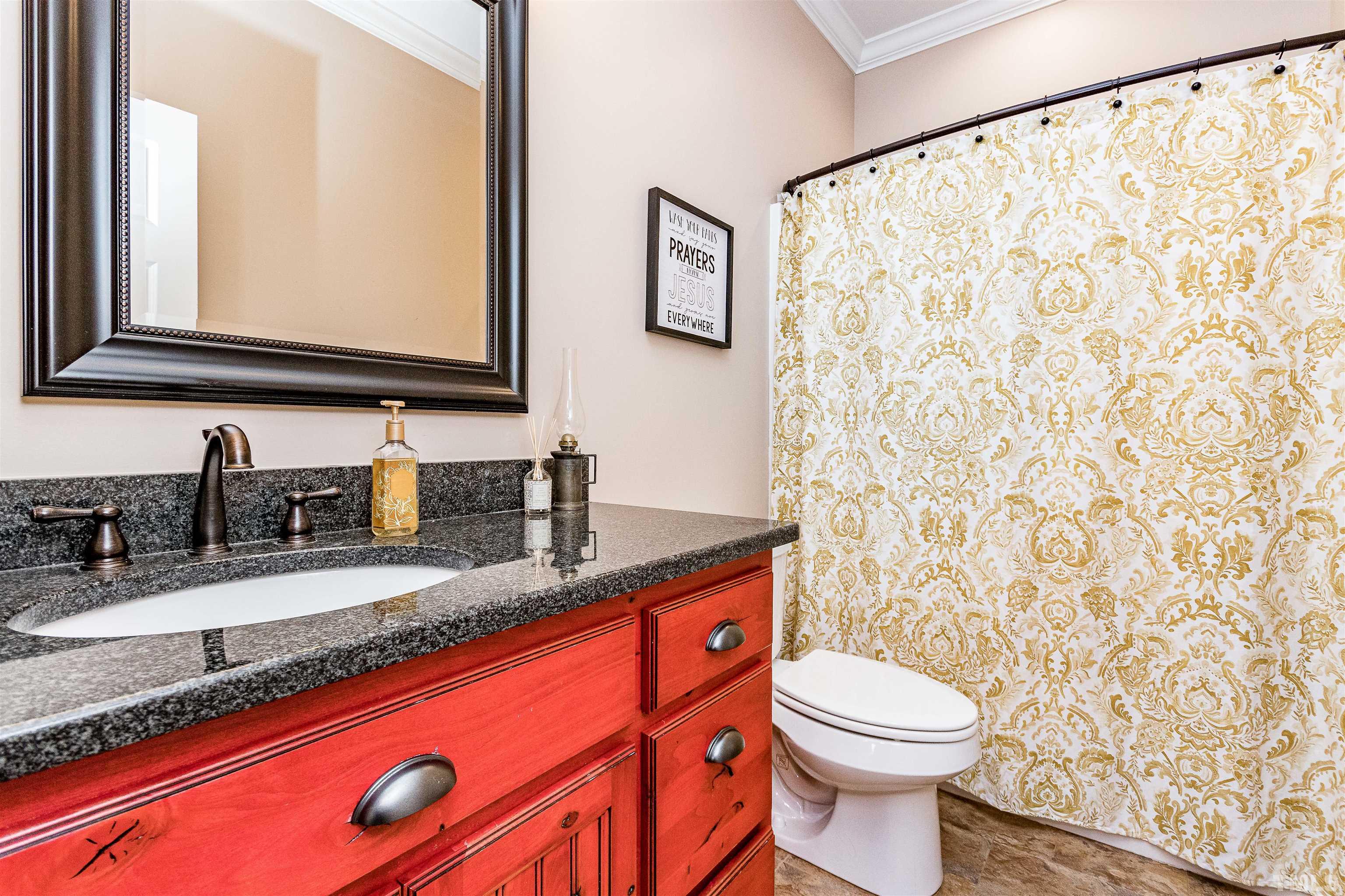 4300 Debnam Road Zebulon, NC 27597 - Photo 39 of 54 a bathroom with a granite countertop sink mirror vanity and toilet