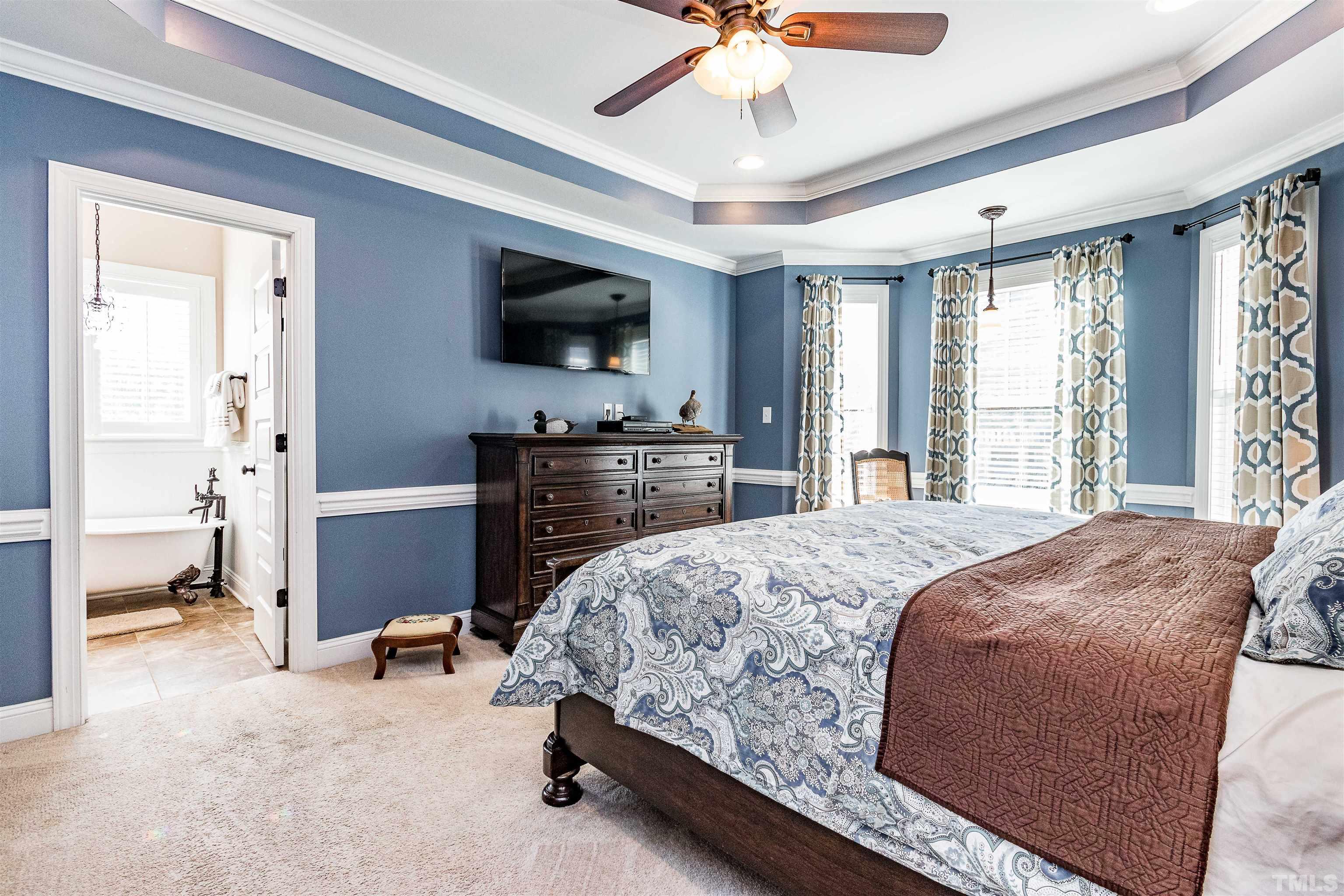4300 Debnam Road Zebulon, NC 27597 - Photo 40 of 54 a bedroom with a bed and a flat screen tv