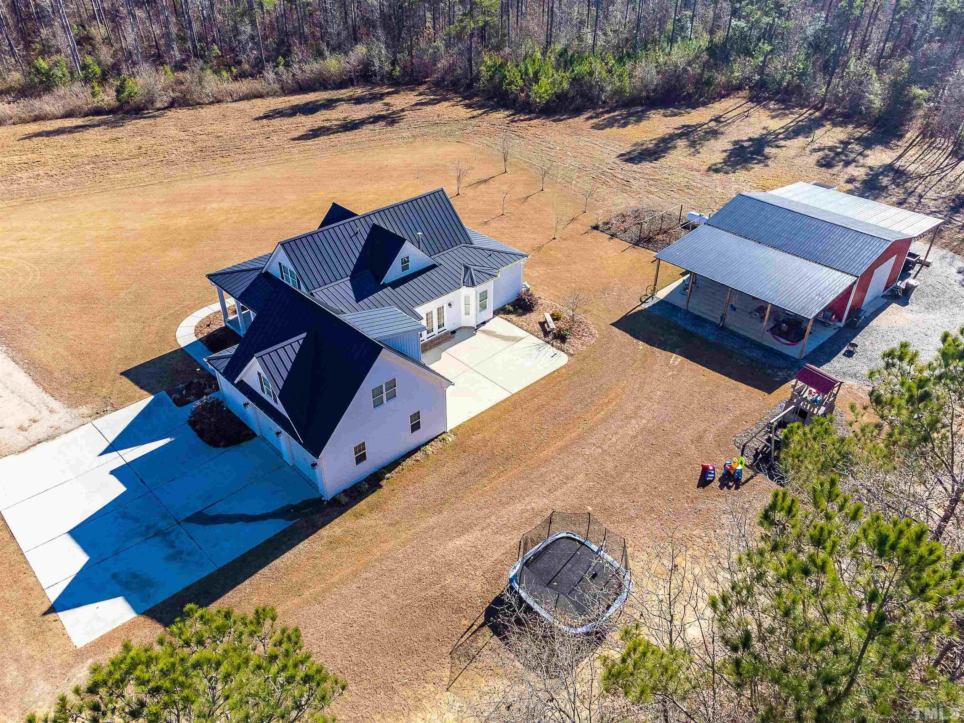 4300 Debnam Road Zebulon, NC 27597 - Photo 5 of 54 an aerial view of a house with outdoor space