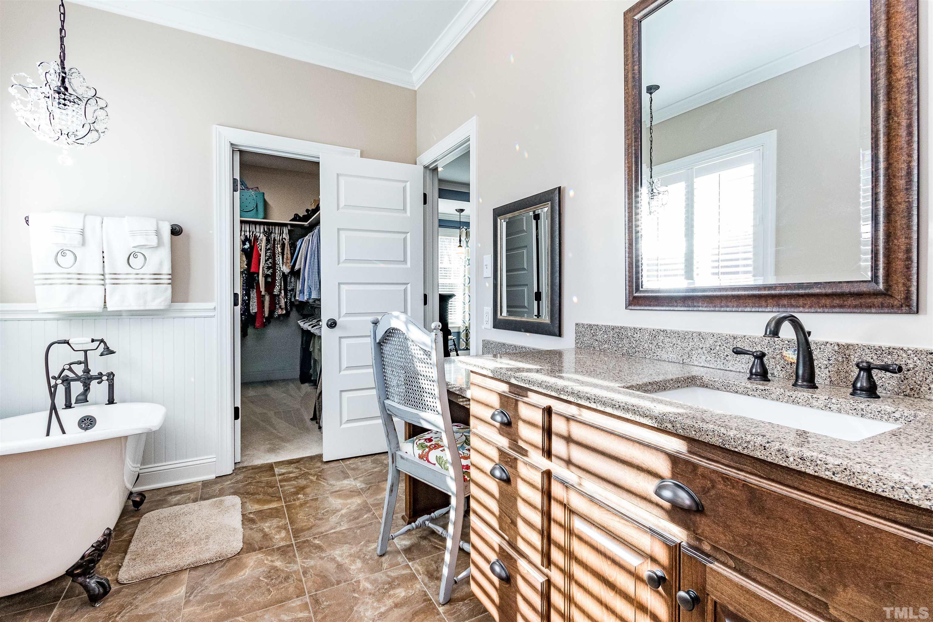 4300 Debnam Road Zebulon, NC 27597 - Photo 44 of 54 a spacious bathroom with a sink double vanity and a tub