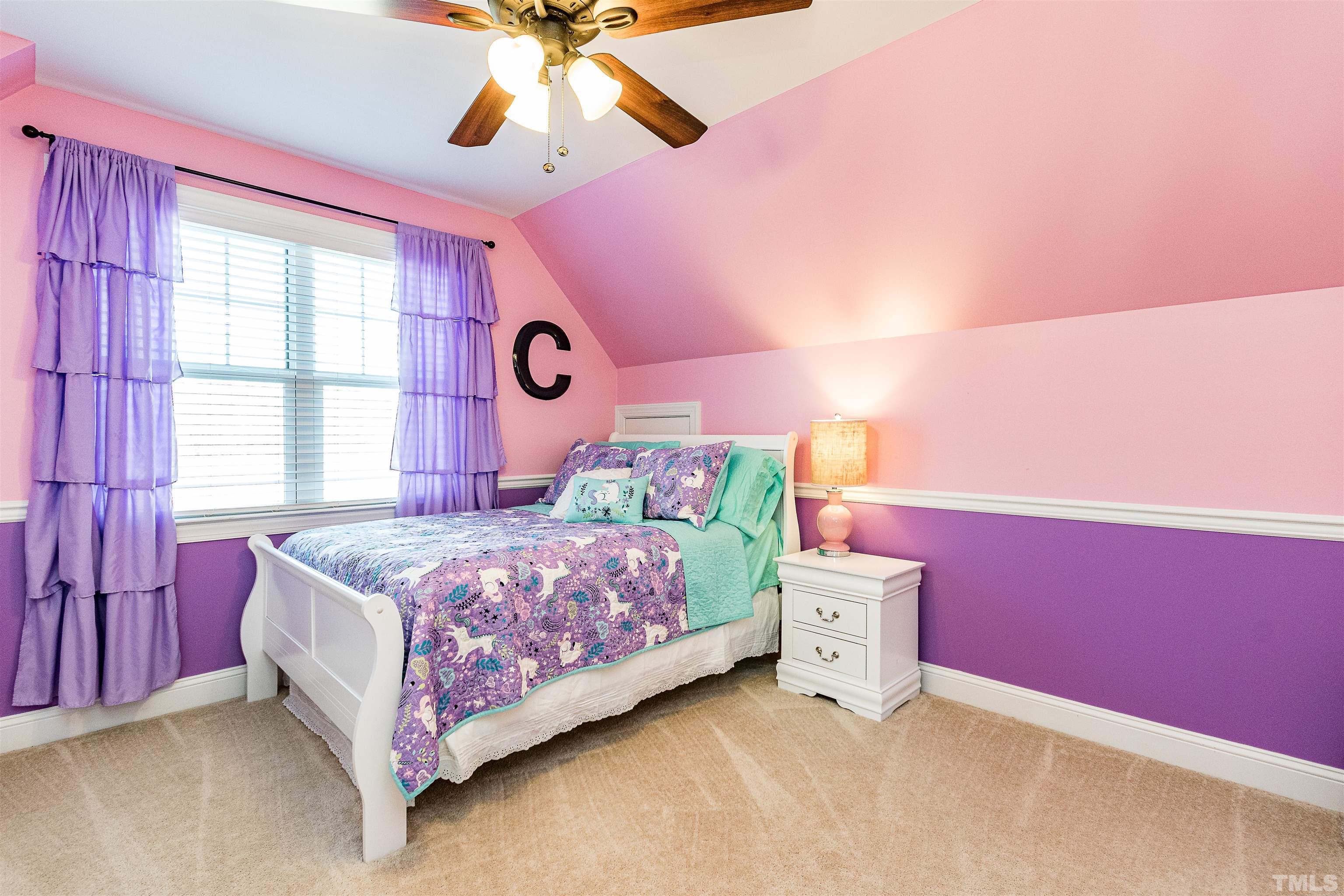 4300 Debnam Road Zebulon, NC 27597 - Photo 48 of 54 a bedroom with a bed and a chandelier