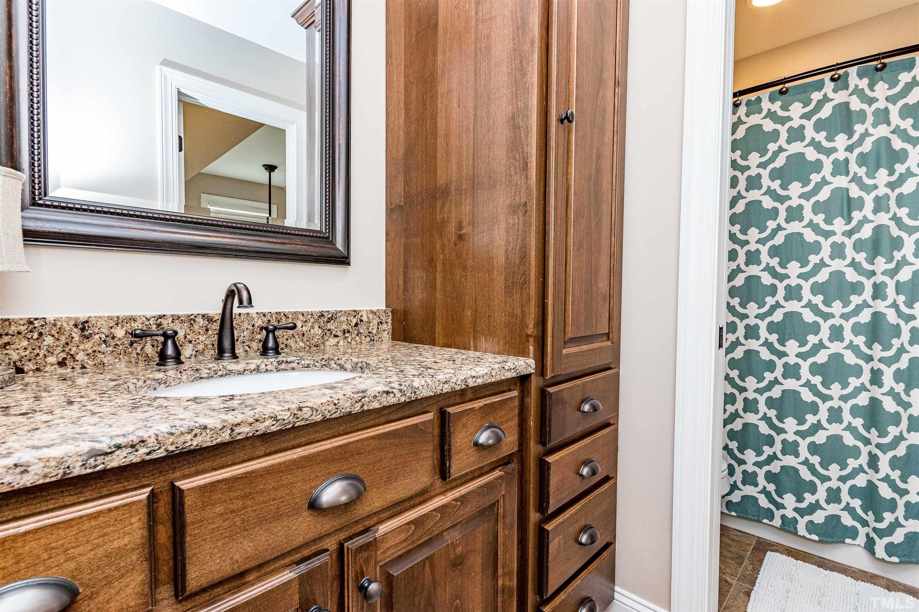 4300 Debnam Road Zebulon, NC 27597 - Photo 50 of 54 a bathroom with a granite countertop sink and a mirror