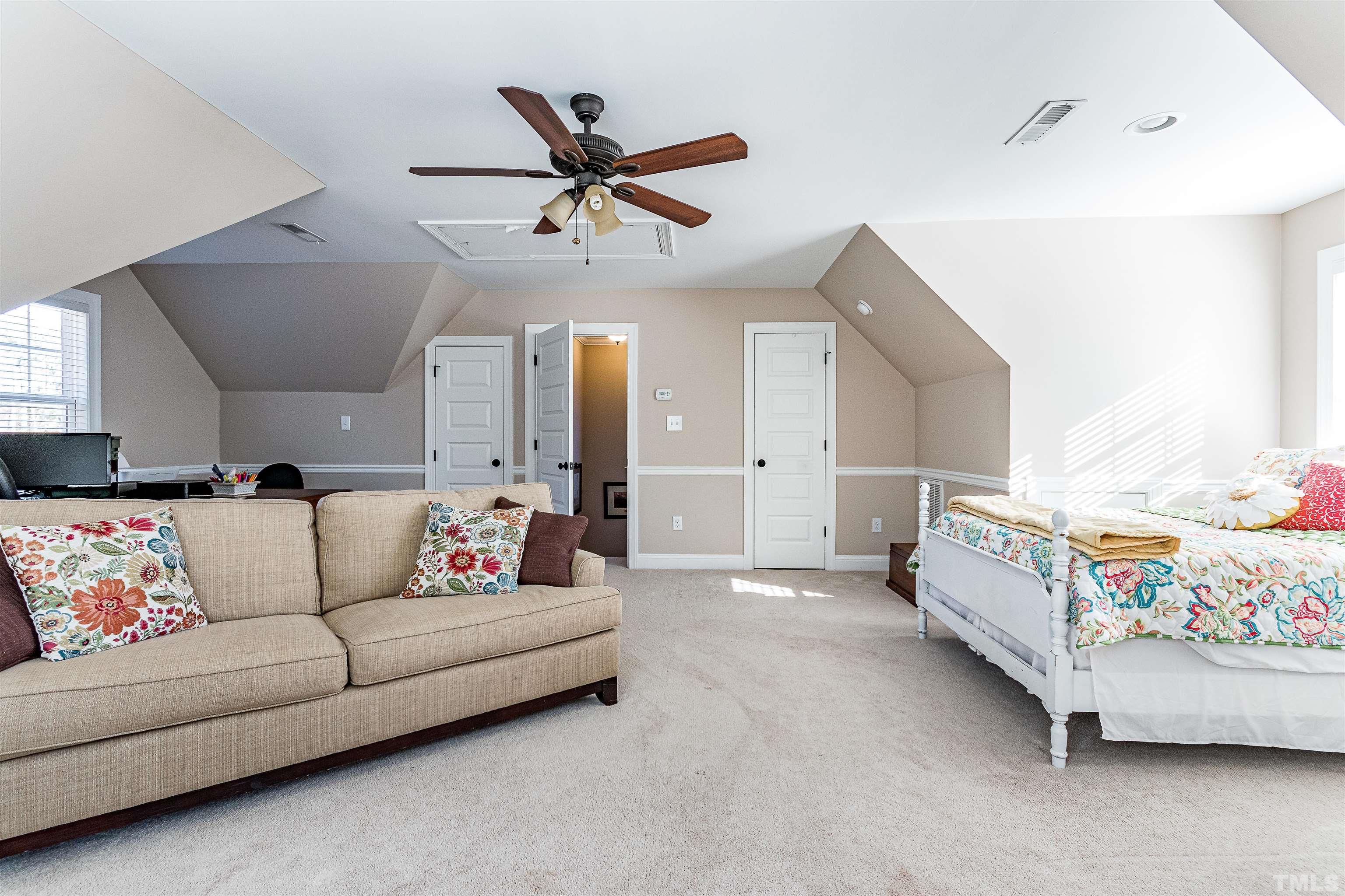 4300 Debnam Road Zebulon, NC 27597 - Photo 54 of 54 a living room with furniture and a chandelier