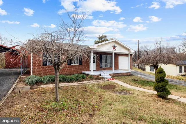 a front view of a house with a yard garage and outdoor seating