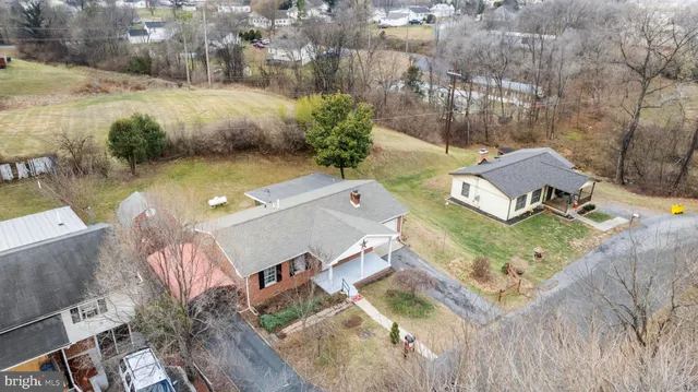 an aerial view of a house with garden space and lake view