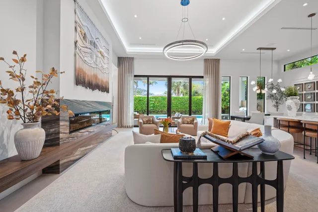 a kitchen with granite countertop a table chairs a sink a window and stainless steel appliances