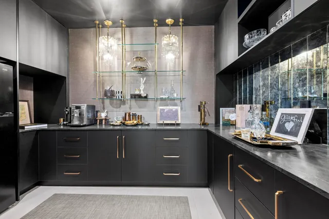 a dining hall with stainless steel appliances kitchen island granite countertop a sink and a view of living room