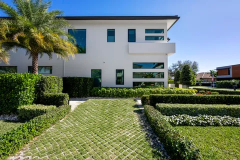 a view of a patio with table and chairs near a yard