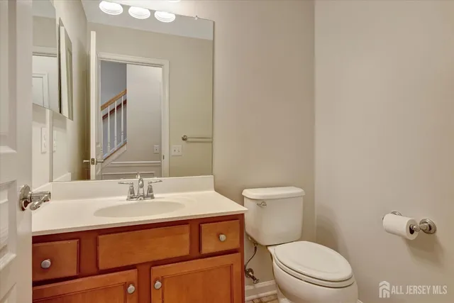 a bathroom with a sink a toilet and mirror