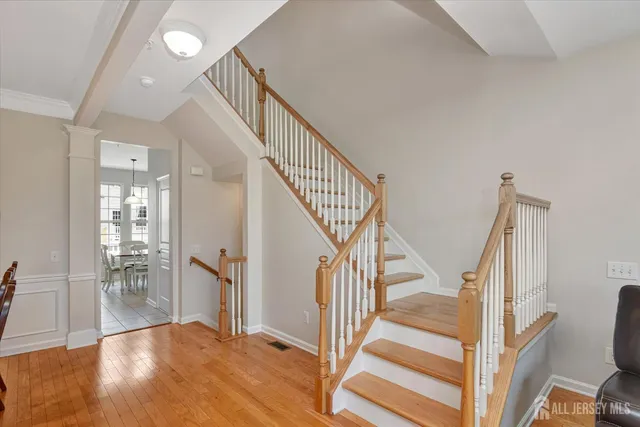 a view of entryway and hall with wooden floor