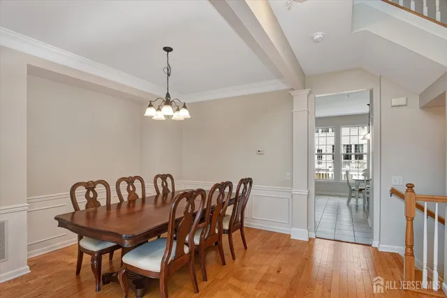 a view of a dining room with furniture wooden floor and chandelier